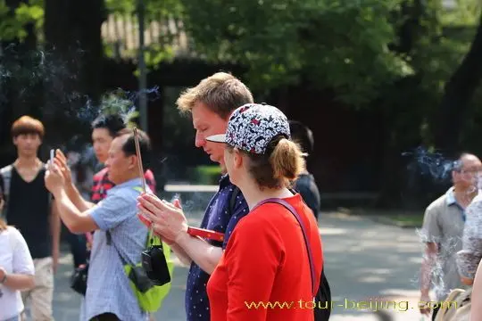 Burning a joss stick and praying