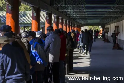 The Long Corridor full of people sitting and standing, playing and singing.
