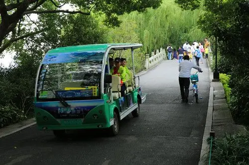 A buggy ( a sightseeing car ) is going down the 4th bridge