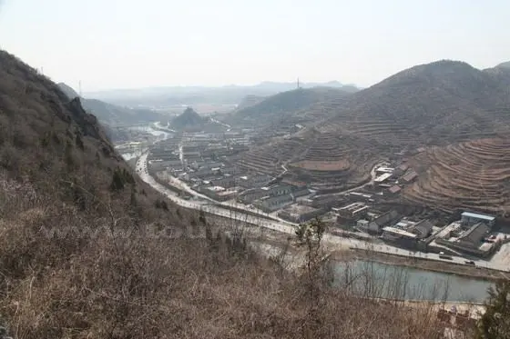 the valley with the village and the river in the middle.