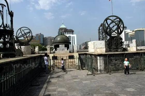 view these instruments with a backdrop of modern buildings nearby
