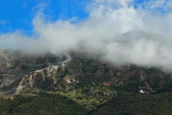 High on the hillside dotted by brilliant house temples and caves
