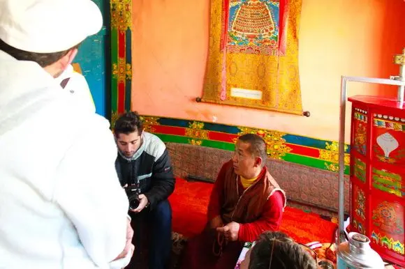 People are having a nice talk with the monk